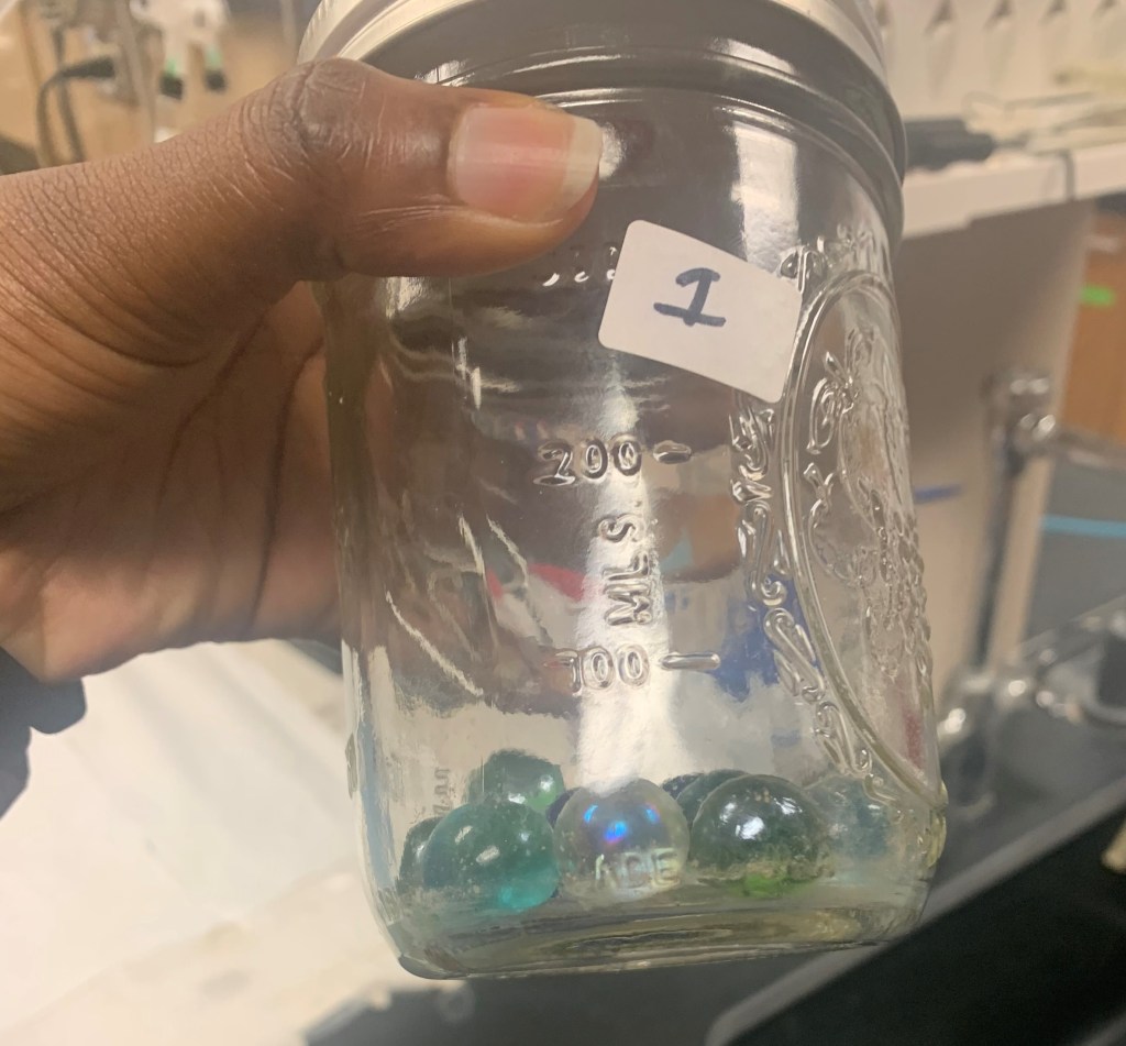 A hand holding a glass of wine

Description automatically generated